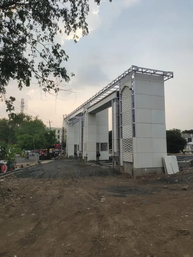Entrance gateway with white cladding and a jali panel